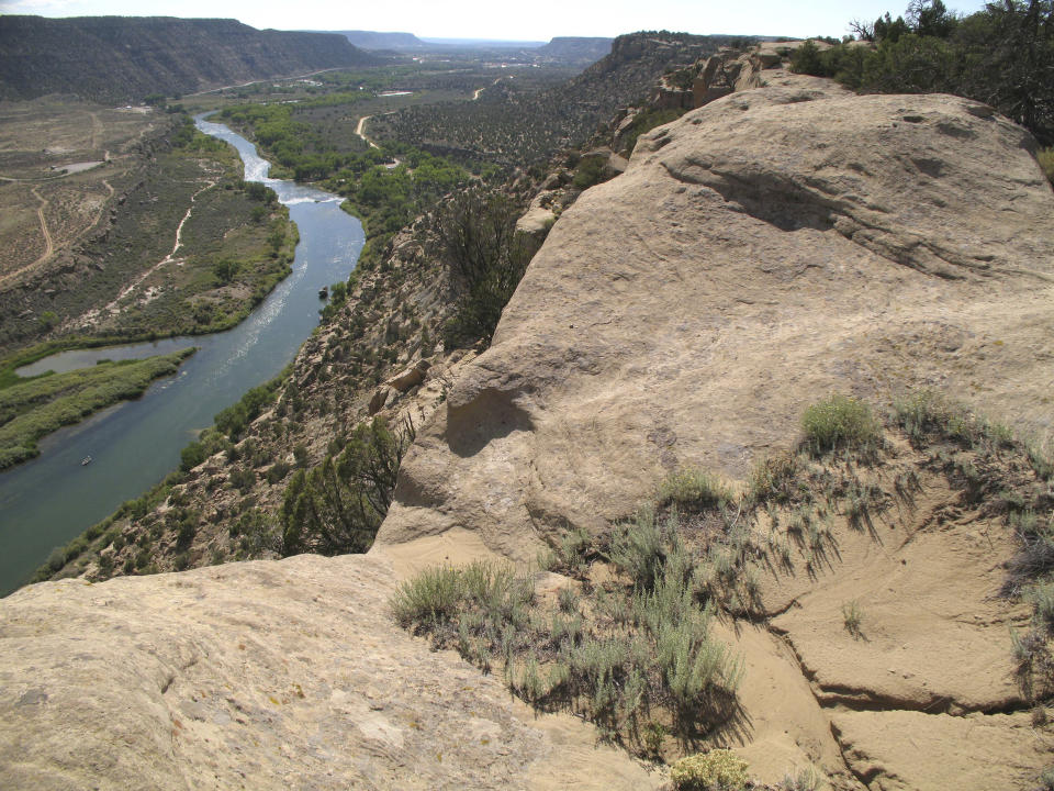 FILE - The San Juan River flows downstream to Navajo Dam, N.M., on Sept. 14, 2008. A Native American tribe has agreed to lease more of its water to help address dwindling supplies in the Colorado River Basin, officials announced Thursday, Jan 20, 2022. The agreement involves the Jicarilla Apache Nation, the New Mexico Interstate Stream Commission and The Nature Conservancy. (AP Photo/Susan Montoya Bryan, File)