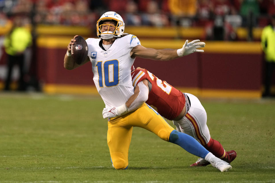 Los Angeles Chargers quarterback Justin Herbert (10) is sacked by Kansas City Chiefs linebacker Drue Tranquill during the second half of an NFL football game Sunday, Oct. 22, 2023, in Kansas City, Mo. (AP Photo/Charlie Riedel)