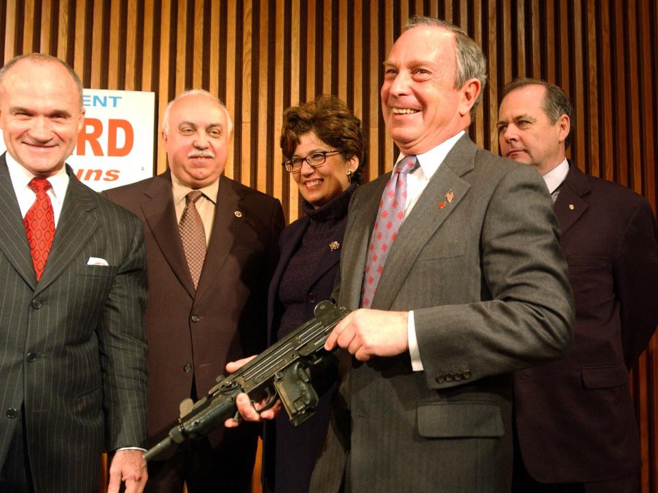 New York City Mayor Michael Bloomberg (R) holds a gun during a news conference with New York Police Commissioner Raymond W. Kelly (L) to announce a gun buy back program April 15, 2002 in New York City. Operation Gun-Stop will reward $1,000 to anyone providing information leading to the arrest of anyone possessing an illegal handgun.