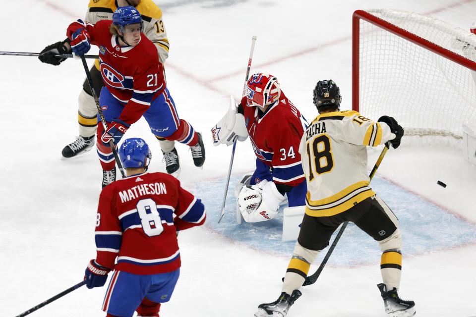 Boston Bruins' Pavel Zacha (18) watches as the shot by Charlie McAvoy gets past Montreal Canadiens' Jake Allen (34) during the first period of an NHL hockey game Saturday, Nov. 18, 2023, in Boston. (AP Photo/Michael Dwyer)