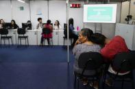 People wait at a Braskem service center run for residents affected by the petrochemical company's rock salt mining in Maceio