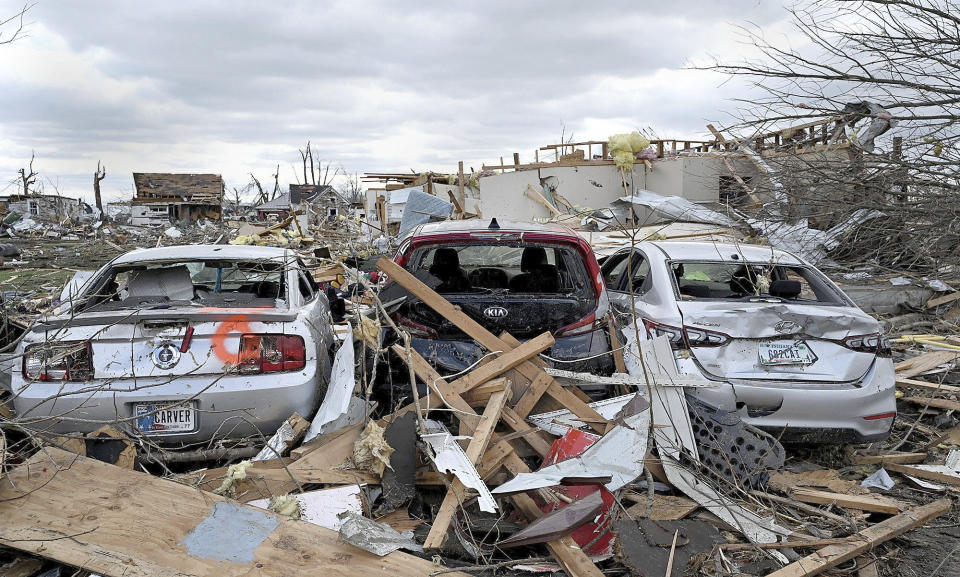 A trio of destroyed cars and debris are seen in a neighborhood on the south side of Sullivan, Ind., Saturday, April 1, 2023, after a tornado moved through the area late the night before. (Joseph C. Garza/The Tribune-Star via AP)