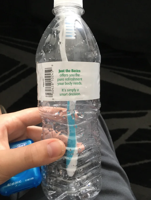 a toothbrush in a water bottle