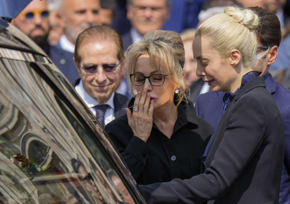 Family members of former Italian Premier Silvio Berlusconi, from left, brother Paolo, daughter Marina, partner Marta Fascina, bid the last farewell to the casket of Silvio Berlusconi at the end of his state funeral outside the Milan's Gothic Cathedral in northern Italy, Wednesday, June 14, 2023. Berlusconi died at the age of 86 on Monday in a Milan hospital where he was being treated for chronic leukemia. (AP Photo/Luca Bruno)