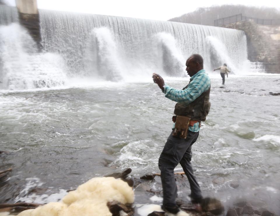 Assistant Professor of Structural Geology Folarin 'Fola' Kolawole and his staff from the Columbia University Lamont-Doherty Earth Observatory does fieldwork looking for clues related to the 4.8 magnitude earthquake of April 5. Here Prof. Kolawole at the foot of the Solitude Dam in High Bridge, Hunterdon County, where he measured cracks and photographed the outcropping of large rocks at the foot of the falls.