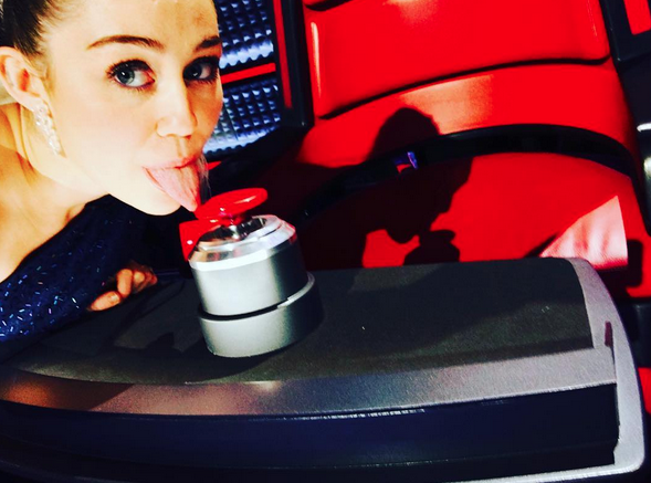 Miley Cyrus following the announcement that she’ll be joining the upcoming season of “The Voice" as the show’s key adviser: "Lickin @xtina buttonz! @nbcthevoice #keyadviser #season10” -@mileycyrus (Photo: Instagram)