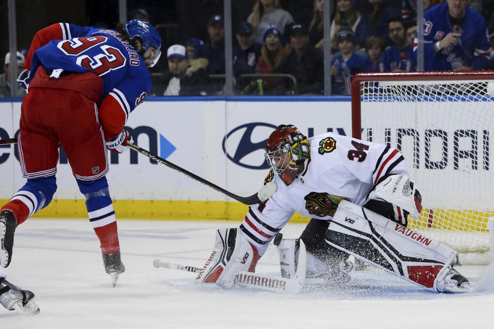 Chicago Blackhawks goaltender Petr Mrazek (34) makes a save against New York Rangers center Mika Zibanejad (93) during the first period of an NHL hockey game, Saturday, Dec. 3, 2022, in New York. (AP Photo/Jessie Alcheh)