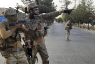 Afghan Special forces patrol a deserted street during fighting with Taliban fighters, in Lashkar Gah, Helmand province, southern Afghanistan, Tuesday, Aug. 3, 2021. The Taliban pressed ahead with their advances in southern Afghanistan on Tuesday, capturing nine out of 10 districts of the Helmand provincial capital, residents and officials said. The fall of Lashkar Gah would be a major turning point in the offensive the Taliban have waged over the past months as U.S. and NATO forces complete their pullout from the war-torn country. (AP Photo/Abdul Khaliq)