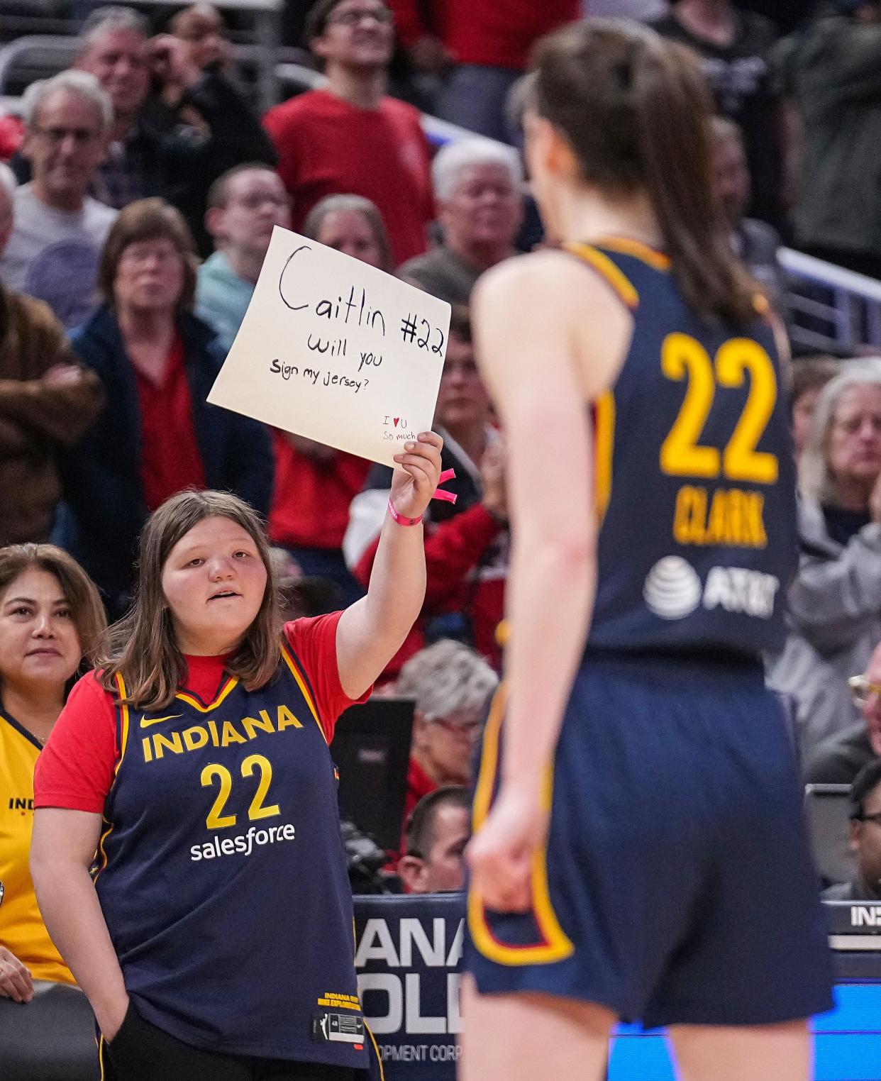An Indiana Fever holds up a sign for Indiana Fever guard Caitlin Clark (22) on Thursday, May 9, 2024, during the preseason game against the Atlanta Dream at Gainbridge Fieldhouse in Indianapolis. The Indiana Fever defeated the Atlanta Dream, 83-80.