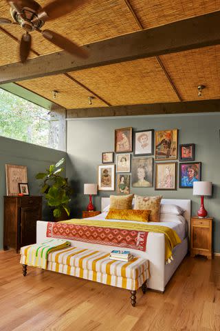 <p>HECTOR MANUEL SANCHEZ; Styling by Christina Wressell</p> The primary bedroom features a striking collection of portraits.