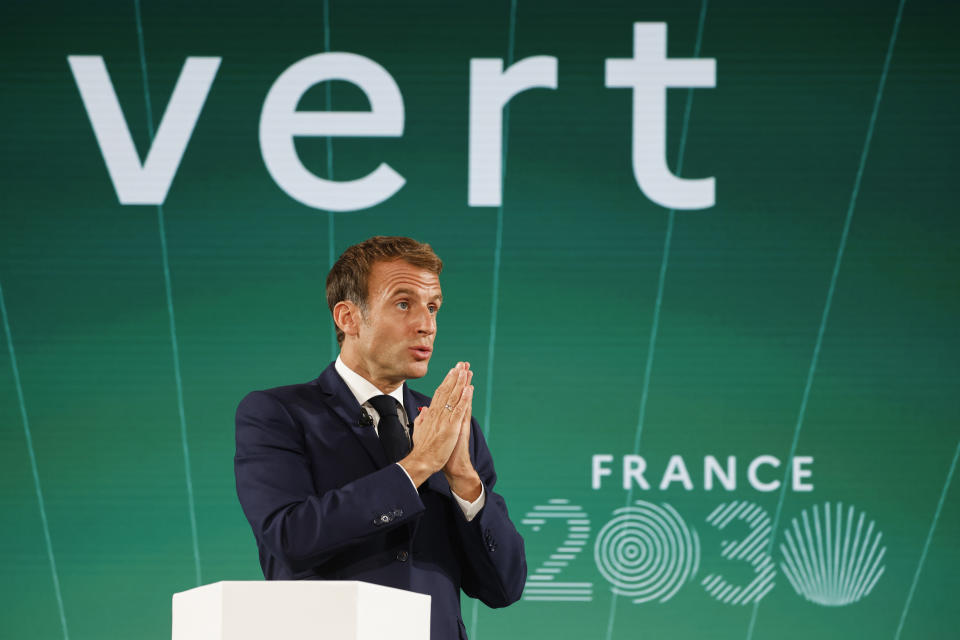 French President Emmanuel Macron speaks during the presentation of "France 2030" investment plan at the Elysee Palace in Paris, Tuesday Oct. 12, 2021. French President Emmanuel Macron details the priority sectors of the "France 2030" plan to "bring out the champions of tomorrow". Behind reads: Green. (Ludovic Marin, Pool Photo via AP)