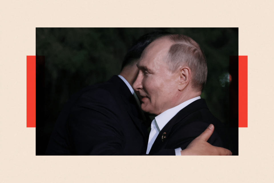 Vladimir Putin and Xi Jinping hug each other