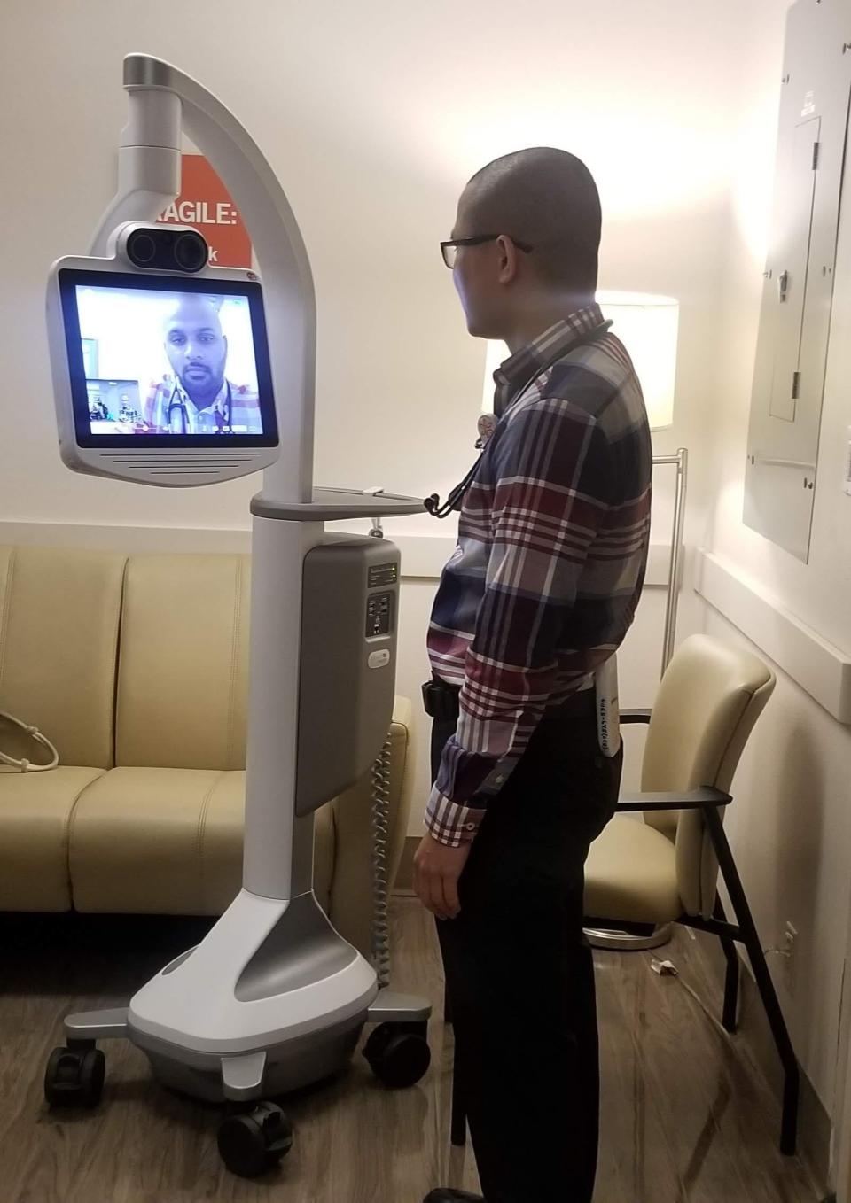 Dr. Giang Bui of St. Elizabeth Community Hospital consults with a fellow physician in Sacramento in this undated photo. Telemedicine also lets a local physician sit with a patient while video conferencing with another physician. The Dignity Health Telemedicine Network TeleICU program was introduced in September 2019. St. Elizabeth's robot lets ICU patients have conversations with physicians for specialized care.