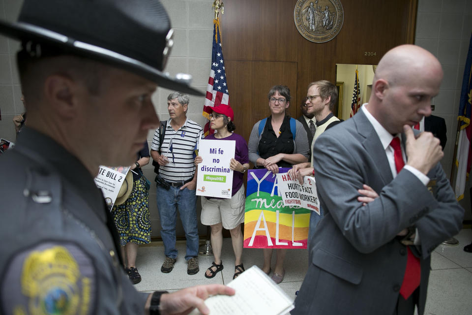 Opponents of the anti-LGBT bill passed by the North Carolina legislature stage a protest outside of House Speaker Tim Moore's office.