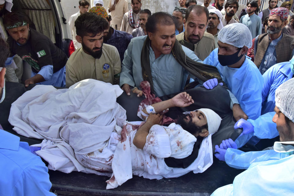 Paramedics and volunteers carry an injured victim of a bomb explosion upon arrival at a hospital, in Quetta, Pakistan, Friday, Sept. 29, 2023. A powerful bomb exploded at a rally celebrating the birthday of Islam's Prophet Muhammad in southwest Pakistan on Friday, killing multiple people and wounding dozens of others, police and a government official said. (AP Photo/Arshad Butt)