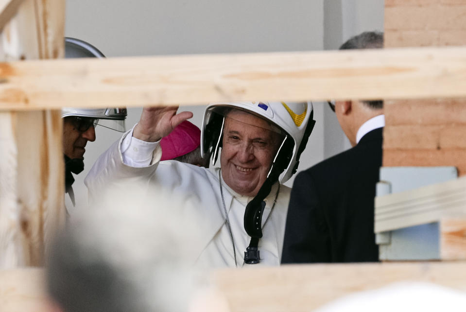 Pope Francis wears a safety helmet as he arrives to visit the earthquake damaged Cathedral of Camerino, Italy, Sunday, June 16, 2019. The pontiff will be celebrating mass in front of the cathedral that was heavily damaged by the 2016 earthquake that hit the central Italian Marche region. (AP Photo/Gregorio Borgia)