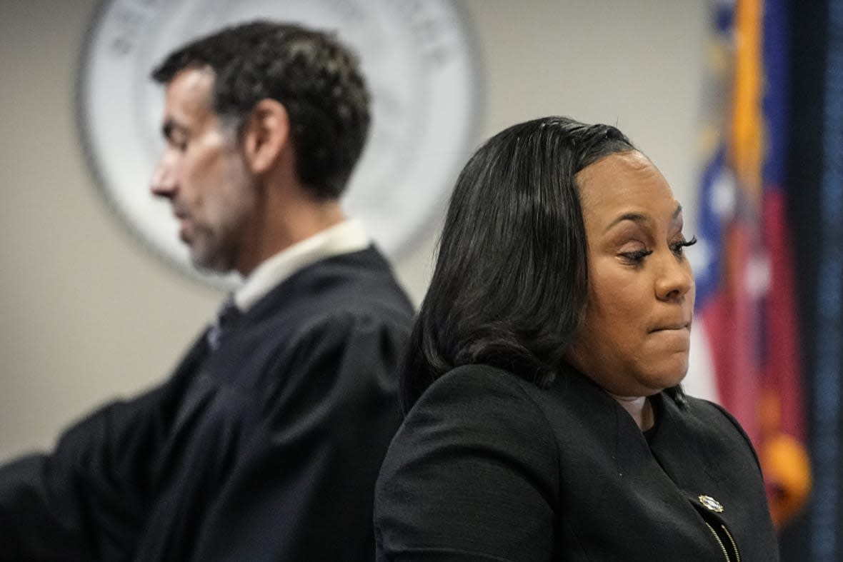 Fulton County District Attorney Fani Willis, right, and Fulton County Superior Court Judge Robert McBurney speak in the Fulton county courthouse, Tuesday, July 11, 2023, in Atlanta. (AP Photo/Brynn Anderson)