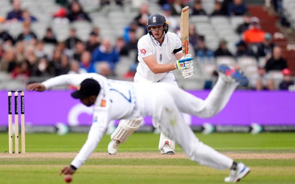 England's Jamie Smith hits the ball past Sri Lanka's Kamindu Mendis for a boundary during day two of the First Rothesay Test match at the Emirates Old Trafford, Manchester