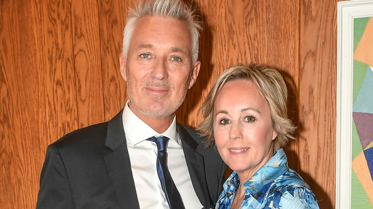 Martin Kemp in a suit and Shirlie Kemp in a blue floral dress