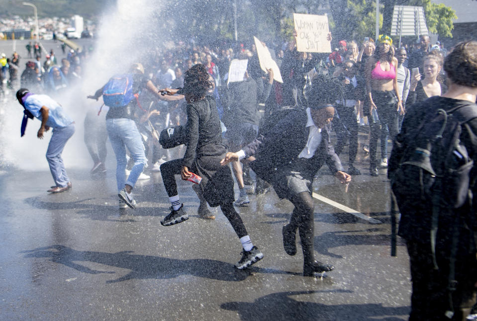 A water cannon is used to disperse demonstrators who were blocking a busy intersection in near to where the World Economic Forum on Africa is being held in Cape Town, South Africa, Wednesday, Sept. 4, 2019. The protesters are demanding that the government crack down on gender-based violence, following a week of brutal murders of young South African women that has shaken the nation. (AP Photo)