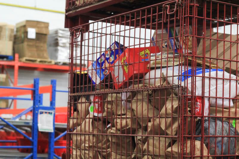 Metal crates of donated food are stacked in an Ottawa Food Bank warehouse in Ottawa