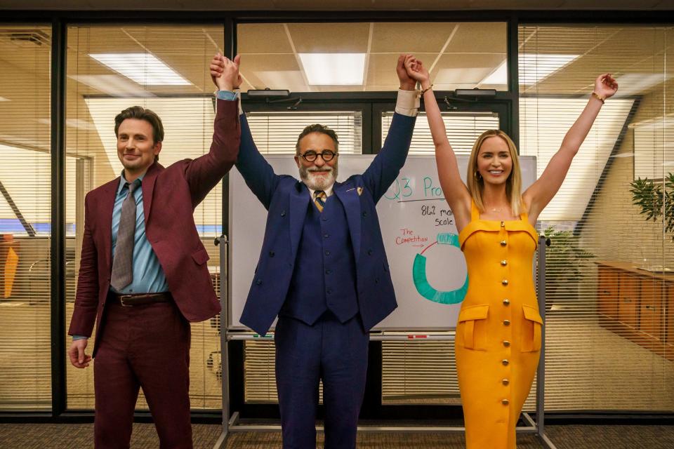 Chris Evans, Andy Garcia, Emily Blunt raising their hands in an office