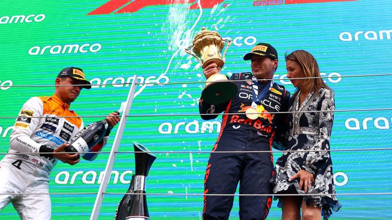  Race winner Max Verstappen of the Netherlands and Oracle Red Bull Racing (C) and Second placed Lando Norris of Great Britain and McLaren (L) celebrate on the podium during the F1 Grand Prix of Great Britain at Silverstone Circuit on July 09, 2023 in Northampton, England.