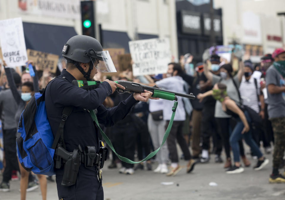 FILE - A police officer prepares to fire rubber bullets during a protest over the death of George Floyd in Los Angeles, Saturday, May 30, 2020. Supporters of legislation allowing for "bad officers" to be permanently stripped of their badges were twisting arms and calling out opponents on Monday, Aug. 31, 2020, as they struggled for votes on one of the year's top policing reform bills. (AP Photo/Ringo H.W. Chiu, File)