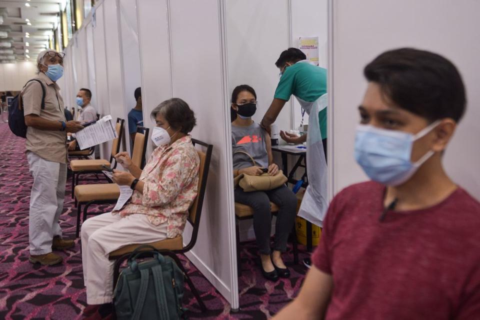 A health worker administers a dose of the AstraZeneca Covid-19 vaccine at the IDCC Ideal Convention Centre Shah Alam May 31, 2021. — Picture by Miera Zulyana