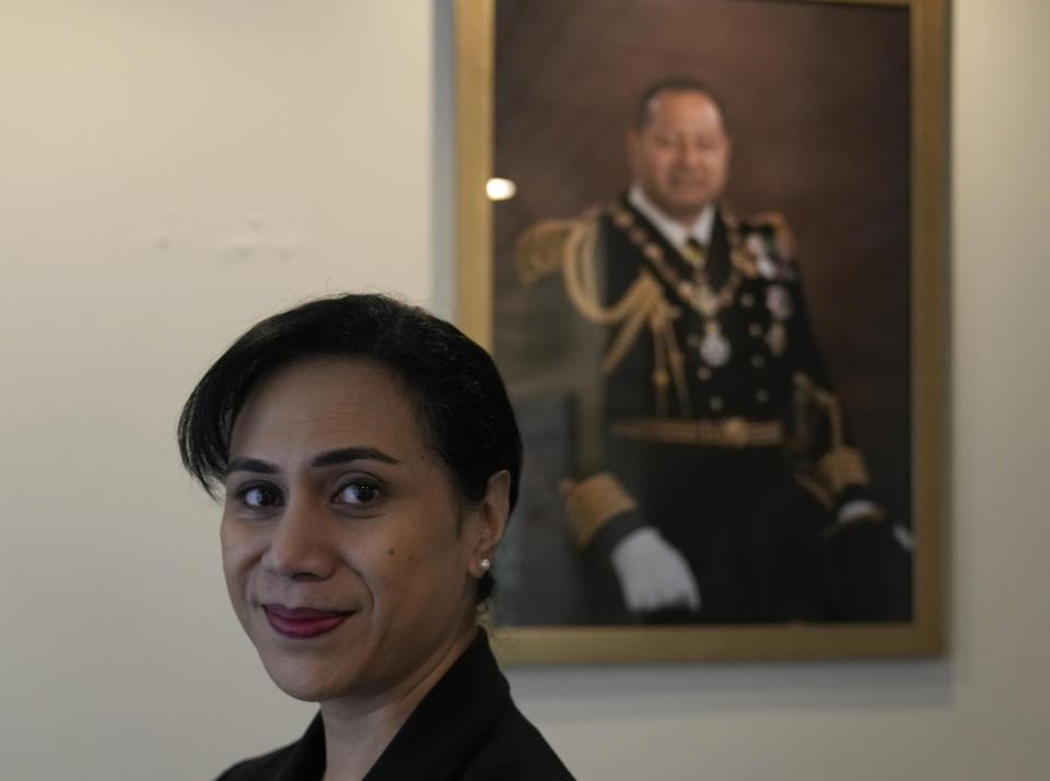 Tonga High Commissioner to the UK, Titilupe Fanetupouvava'u Tu'ivakano poses for a photograph in front of a portrait of the King of Tonga Tupou VI during an interview with The Associated Press, at the High Commission in London, Monday, May 30, 2022. As well as celebrating Queen Elizabeth II’s Platinum Jubilee, Tu’ivakano will also remember her great- grandmother Queen Salote Tupou III, who endeared herself to Britons as she rode through the streets of London in an open carriage during Elizabeth’s coronation parade in 1953. (AP Photo/Alastair Grant)