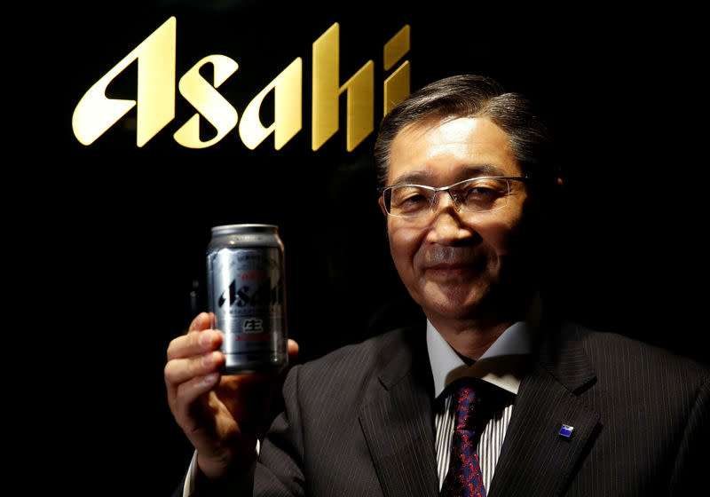 FILE PHOTO : Asahi Group Holdings President and COO Akiyoshi Koji poses for a photo with an Asahi Super Dry beer can at its headquarters in Tokyo, Japan, May 17, 2016. REUTERS/Toru Hanai/File photo