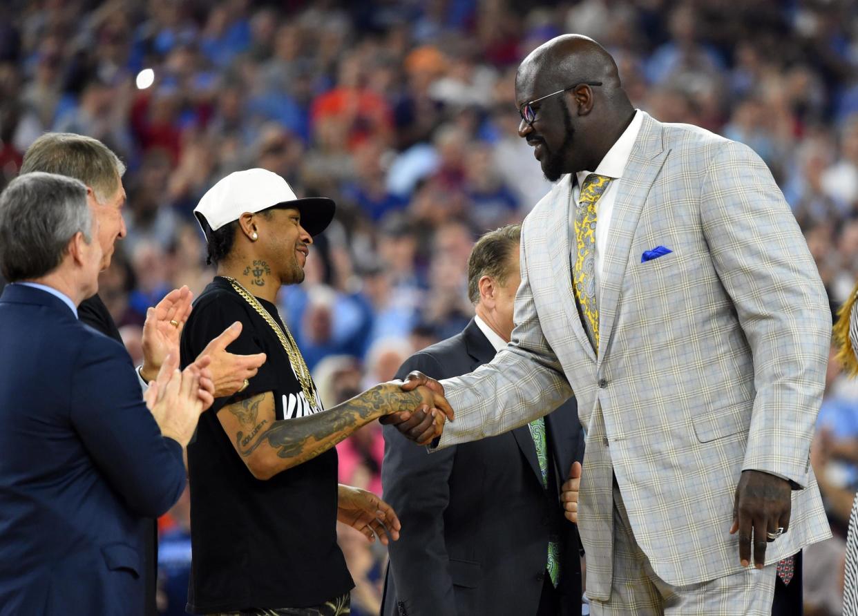 Shaquille O'Neal shakes hands with Allen Iverson as they are introduced at halftime of the championship game of the 2016 NCAA Men's Final Four after being inducted into the basketball hall of fame. The two are teaming up again with Reebok, the shoe company announced.