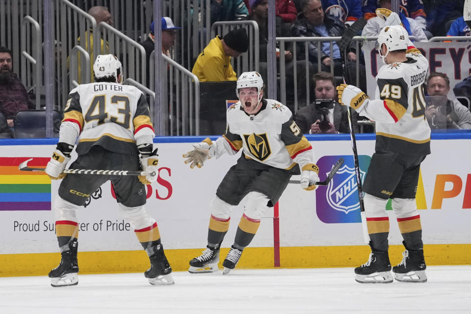 Vegas Golden Knights' Sheldon Rempal, center, celebrates with Paul Cotter, left, and Ivan Barbashev after scoring a goal against the New York Islanders during the second period of an NHL hockey game Tuesday, Jan. 23, 2024, in Elmont, N.Y. (AP Photo/Frank Franklin II)