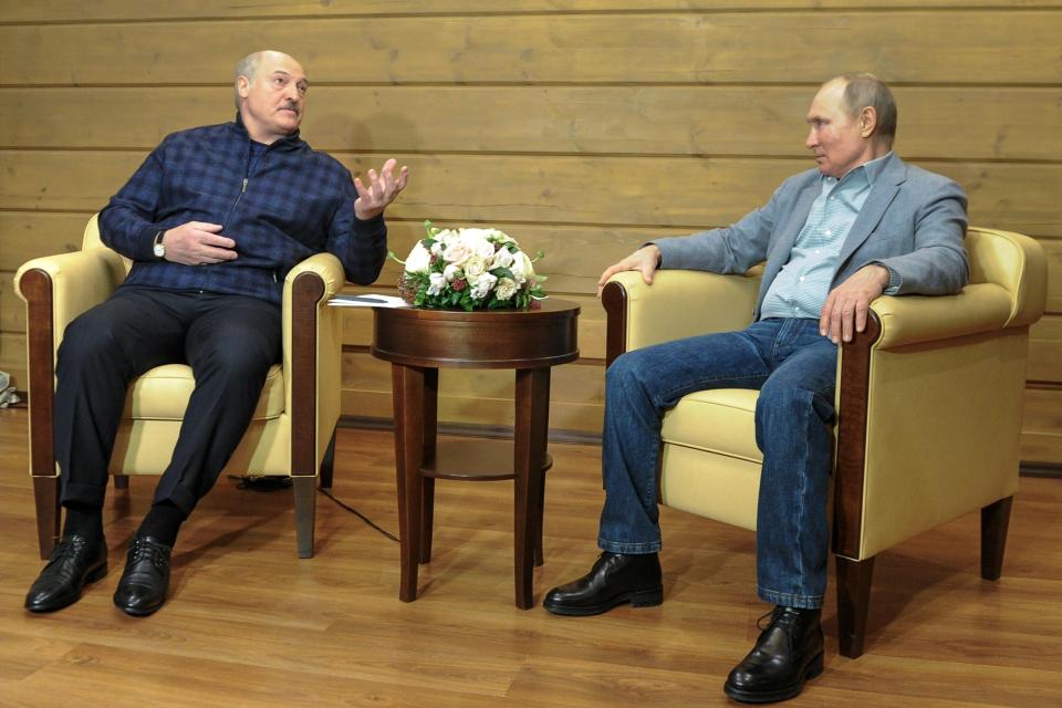 Belarusian President Alexander Lukashenko, left, gestures while speaking to Russian President Vladimir Putin during their meeting in the Black Sea resort of Sochi, Russia, Monday, Feb. 22, 2021. (Alexei Druzhinin, Sputnik, Kremlin Pool Photo via AP)