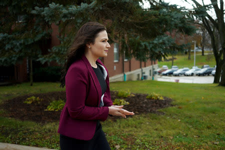 FILE PHOTO: Democratic congressional candidate Abby Finkenauer walks to her polling location during midterm elections at St. Collumbkille Catholic Church in Dubuque, Iowa, U.S. November 6, 2018. REUTERS/KC McGinnis/File Photo