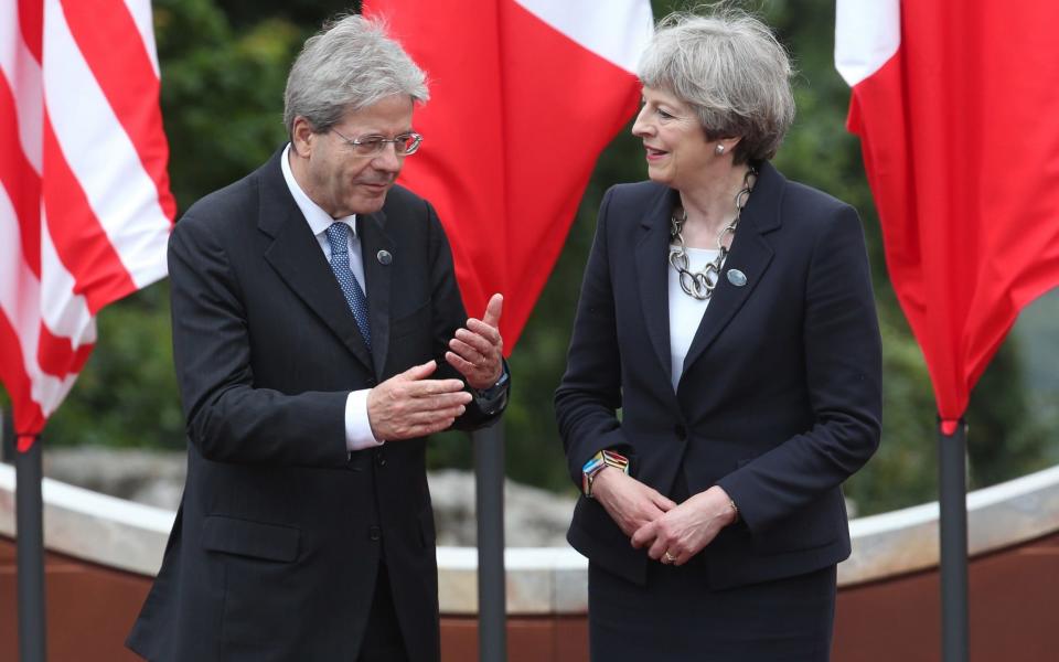 Italy and the UK, led by Paolo Gentiloni and Theresa May, face almost identical GDP forecasts, the EC said - Getty Images Europe