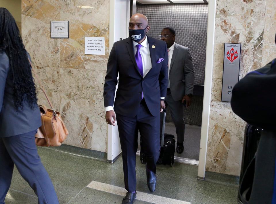 Attorney Damario Solomon-Simmons, center, attends a hearing at the Tulsa County Courthouse, Monday, May 2, 2022, in Tulsa, Okla. A judge ruled that a lawsuit can proceed that seeks reparations for survivors and descendants of victims of the massacre.