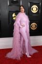 <p>Like Lizzo, Kacey Musgraves showed up in a detailed cape, adorned in pink feathers, that she later opened up to reveal the rest of her look: a Valentino catsuit and matching stilettos. </p>