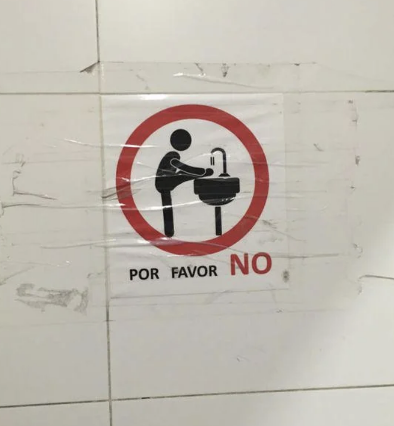 Un cântec care arată o persoană care își spală picioarele în chiuvetă, cu un cerc și o linie care trece prin el și textul „por favor” NU