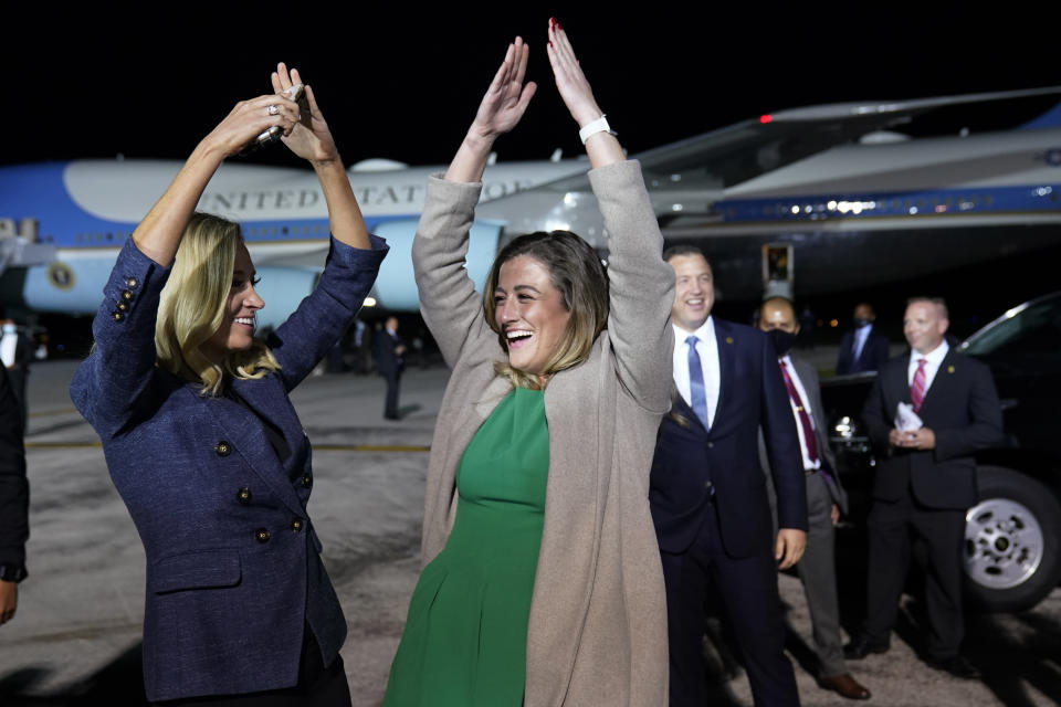 FILE - White House press secretary Kayleigh McEnany and White House legislative aide Cassidy Hutchinson dance to the song YMCA as President Donald Trump ends a campaign rally at Eugene F. Kranz Toledo Express Airport, Sept. 21, 2020, in Swanton, Ohio. (AP Photo/Alex Brandon, File)