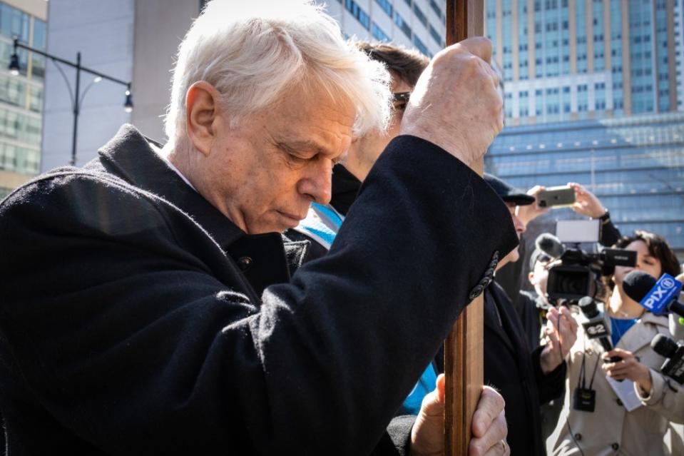 Jonathan Fields, 67, carries a cross during the “Way of the Cross” procession over the Brooklyn Bridge. Stefan Jeremiah for NY Post