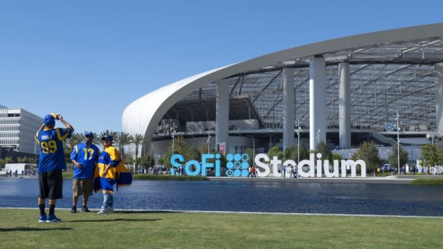 Los Angeles Rams fans pose for a picture in front of SoFi Stadium.