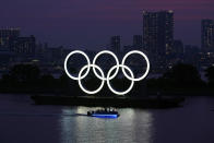 FILE - In this June 3, 2020, photo, the Olympic rings float in the water at sunset in the Odaiba section in Tokyo. The postponed Tokyo Olympics have again reached the one-year-to-go mark. But the celebration is small this time with more questions than answers about how the Olympics can happen in the middle of a pandemic. That was before COVID-19 postponed the Olympics and pushed back the opening to July 23, 2021. (AP Photo/Eugene Hoshiko, File)