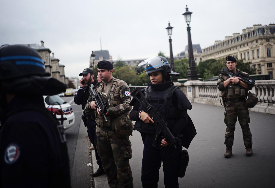 Armed police officers and soldiers patrol after an incident at the police headquarters after in Paris, Thursday, Oct. 3, 2019. A French police union official says an attacker armed with a knife has killed one officer inside Paris police headquarters before he was shot and killed. (AP Photo/Kamil Zihnioglu)