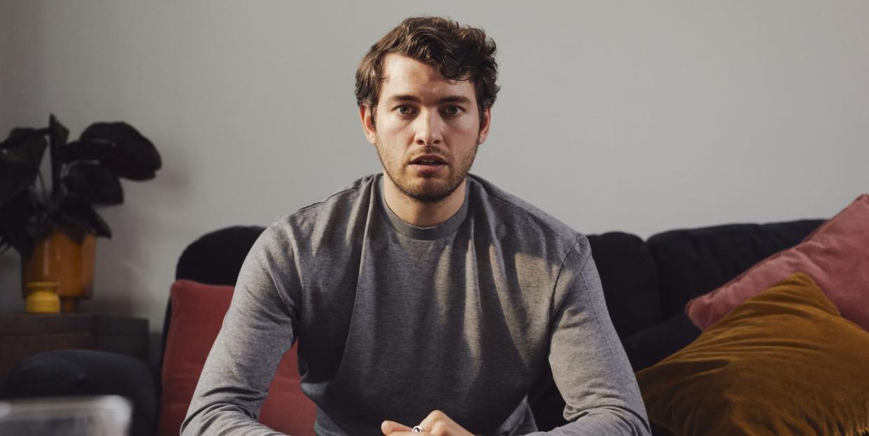 young man facing the camera looking worried