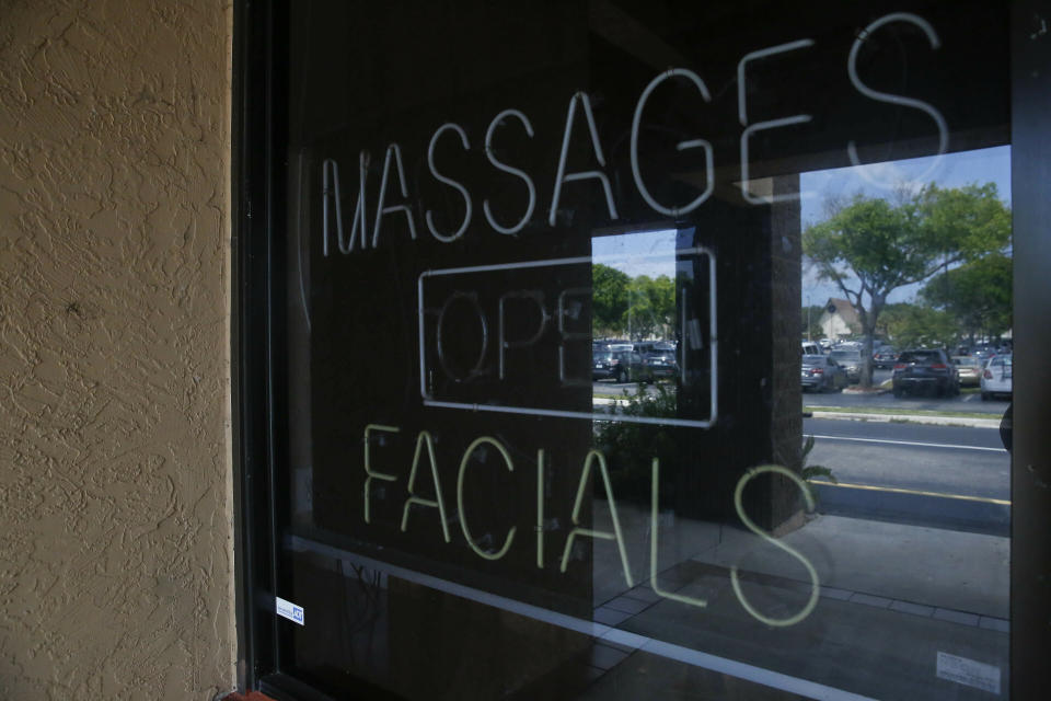 FILE - This March 26, 2019 file photo, shows a sign in the window of the front entrance of the Orchids of Asia Day Spa in Jupiter, Fla. Florida prosecutors will try to save their prostitution solicitation case against New England Patriots owner Robert Kraft when they argue before an appellate court Tuesday, June 30, 2020, that his rights weren't violated when police secretly video recorded him allegedly paying for sex at Orchids of Asia. (AP Photo/Brynn Anderson, File)