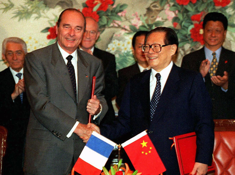 FILE - In this photo released by Xinhua News Agency, then French President Jacques Chirac, left, and his then Chinese counterpart Jiang Zemin shake hands as they exchange signed documents during a ceremony at Beijing's Zhongnanhai leader's compound, May 16, 1997. Chinese state TV said Wednesday, Nov. 30, 2022, that Jiang has died at age 96. (Xinhua via AP)