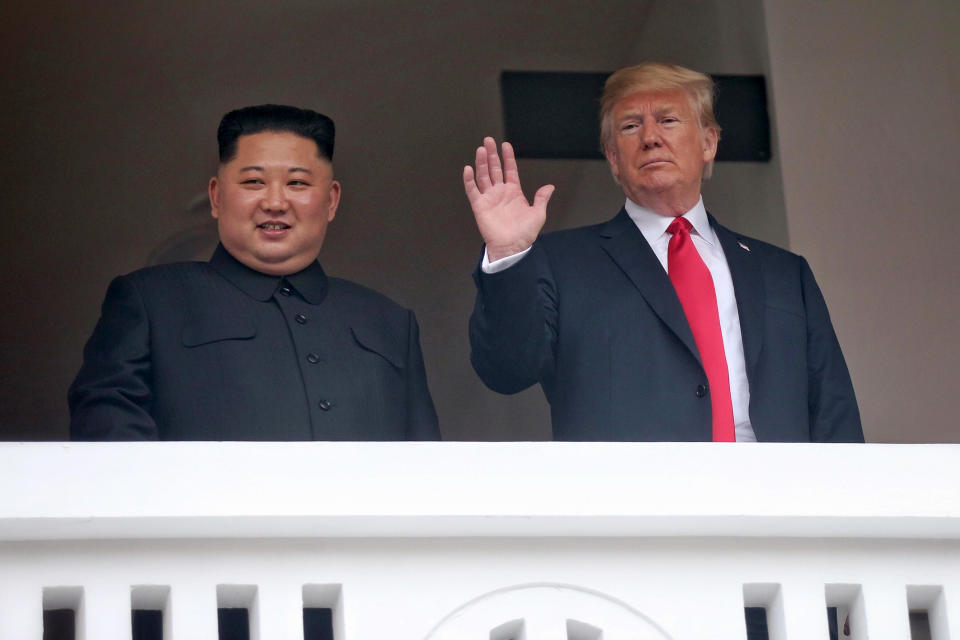 U.S. President Donald Trump, right, waves with North Korean leader Kim Jong Un at the Capella resort on Sentosa Island Tuesday, June 12, 2018, in Singapore. (Kevin Lim/The Straits Times via AP)