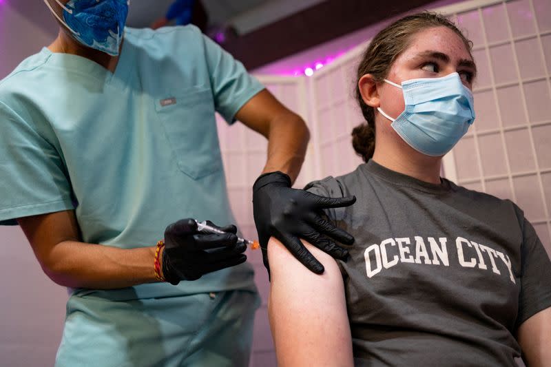 FILE PHOTO: People receive COVID-19 boosters targeting Omicron