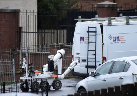 A bomb disposal robot opens a door of a suspected vehicle at the scene of a security alert in Londonderry, Northern Ireland, January 21, 2019. REUTERS/Clodagh Kilcoyne